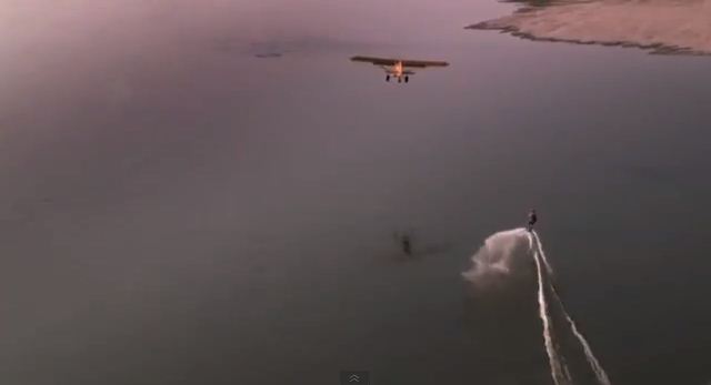 Wakeboarder towed by a plane